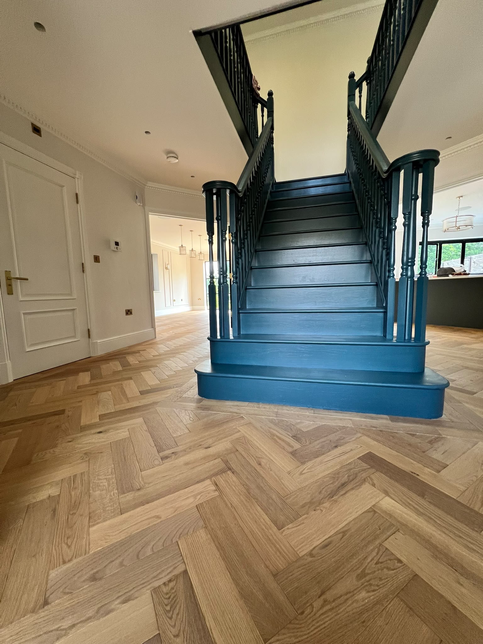 Complete hallway renovation with marble flooring, LED ceiling detail and bespoke staircase